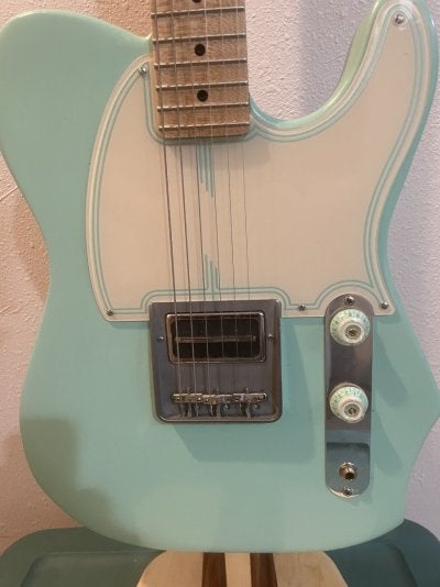 green pickguard on guitar.jpg
